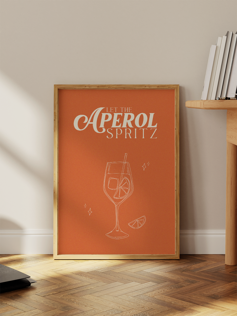 Gerahmtes Poster mit dem Spruch „Let the Aperol Spritz“ auf kräftigem Orange, illustriert mit einem Aperol-Glas, Eiswürfel und Orangenscheibe – ALMOST A BRAND